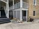 Cozy exterior featuring an outdoor entrance, deck access, and functional hose reel at 65 Vanderhorst St # C, Charleston, SC 29403