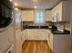 Modern kitchen with stainless steel appliances, white cabinets and countertops at 65 Vanderhorst St # C, Charleston, SC 29403