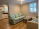 Cozy living room featuring hardwood floors and a comfortable couch beneath a window at 65 Vanderhorst St # C, Charleston, SC 29403