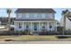 Attractive two-story home with a covered porch, detailed trim, and a neatly manicured front lawn at 711 Blueway Ave, Summerville, SC 29486