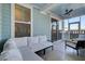 Screened porch with a cozy seating area, fan and views of the backyard at 711 Blueway Ave, Summerville, SC 29486