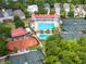 A high angle aerial view showing a tennis court and a community pool and clubhouse in a luxury neighborhood at 74 Hospitality St, Mount Pleasant, SC 29464