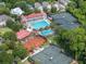 Aerial view of a community clubhouse with a large pool and tennis courts surrounded by lush greenery at 74 Hospitality St, Mount Pleasant, SC 29464
