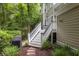 Back deck with white railings, stairs to yard, and lush landscaping at 74 Hospitality St, Mount Pleasant, SC 29464