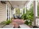 Relaxing back porch with comfortable seating, ceiling fan, and lush greenery at 74 Hospitality St, Mount Pleasant, SC 29464