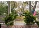 Cozy outdoor space with green plants providing a tranquil, private view from the back porch at 74 Hospitality St, Mount Pleasant, SC 29464