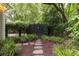 Backyard with stone walkway, wooden gate, and lush green landscaping at 74 Hospitality St, Mount Pleasant, SC 29464