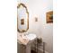 Charming powder room features a pedestal sink, gold-framed mirror, and decorative accents at 74 Hospitality St, Mount Pleasant, SC 29464