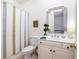 Bathroom with classic white fixtures, framed mirror, and neutral-toned shower curtain at 74 Hospitality St, Mount Pleasant, SC 29464