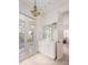 Bathroom featuring a decorative chandelier, white vanity with marble countertops and french doors at 74 Hospitality St, Mount Pleasant, SC 29464