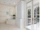 Bathroom featuring a soaking tub, built in cabinet, and french doors to the covered porch at 74 Hospitality St, Mount Pleasant, SC 29464