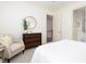 Comfortable bedroom with a soft armchair, wooden dresser, and a view to the bathroom at 74 Hospitality St, Mount Pleasant, SC 29464