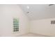 Bright bedroom features a vaulted ceiling and a large window overlooking a leafy view at 74 Hospitality St, Mount Pleasant, SC 29464