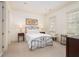 Bright bedroom features a metal bed frame, two windows with coverings, and neutral walls at 74 Hospitality St, Mount Pleasant, SC 29464