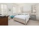 Bright bedroom features a neutral palette, three shuttered windows, and two decorative side tables at 74 Hospitality St, Mount Pleasant, SC 29464
