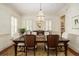 Elegant dining room features a large wooden table, chandelier, and ample natural light at 74 Hospitality St, Mount Pleasant, SC 29464