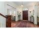 Inviting foyer with a chandelier, dark wood floors, and a view into the living room at 74 Hospitality St, Mount Pleasant, SC 29464