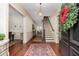 Elegant foyer with hardwood floors, a staircase, and decorative wreath adds a welcoming touch at 74 Hospitality St, Mount Pleasant, SC 29464