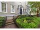 Charming home entrance with a brick path, lush landscaping, and classic exterior lighting at 74 Hospitality St, Mount Pleasant, SC 29464