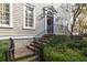 Charming front entrance with brick steps, black railing, and inviting front door at 74 Hospitality St, Mount Pleasant, SC 29464