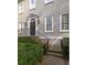 Charming home entrance featuring a black door, decorative wreath, elegant sidelights, and manicured landscaping at 74 Hospitality St, Mount Pleasant, SC 29464