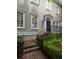 Charming front porch with brick stairs, iron railing, and well-maintained landscaping at 74 Hospitality St, Mount Pleasant, SC 29464