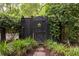 Charming garden gate with mature landscaping and privacy fence offers a tranquil entry at 74 Hospitality St, Mount Pleasant, SC 29464