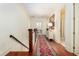 Hallway features wood floors, staircase, and doorway leading to a well-lit bathroom at 74 Hospitality St, Mount Pleasant, SC 29464