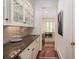 Hallway with a large painting, leading to the kitchen at 74 Hospitality St, Mount Pleasant, SC 29464
