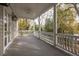 The covered porch features white columns, a ceiling fan, and a painted gray floor at 74 Hospitality St, Mount Pleasant, SC 29464