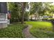 Spacious yard with a well-maintained lawn, mature trees, and a walkway at 74 Hospitality St, Mount Pleasant, SC 29464
