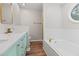 Relaxing bathroom with a soaking tub, bright lights, and a window for natural light at 8340 Coventry Ct, North Charleston, SC 29420