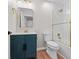 Stylish bathroom with navy vanity, gold fixtures, and shower with glass door and white herringbone tile at 8340 Coventry Ct, North Charleston, SC 29420