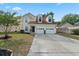 Inviting two-story home with a two-car garage, dormer windows, and a well-manicured lawn at 8340 Coventry Ct, North Charleston, SC 29420