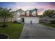 Charming two-story home featuring a well-manicured lawn, two-car garage, and inviting curb appeal at 8340 Coventry Ct, North Charleston, SC 29420