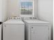 A bright laundry room featuring a washer and dryer beneath a window at 8340 Coventry Ct, North Charleston, SC 29420