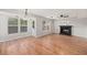 Cozy living room features a decorative fireplace and plenty of natural light from large windows at 8340 Coventry Ct, North Charleston, SC 29420