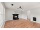 Spacious living room features a fireplace, ceiling fan, and wood-look floors at 8340 Coventry Ct, North Charleston, SC 29420