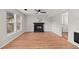 Inviting living room with a cozy fireplace, wood-look floors, and abundant natural light at 8340 Coventry Ct, North Charleston, SC 29420