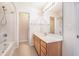 Bathroom featuring a wide mirror above vanity, tile floor, and shower-tub combination at 8739 Grassy Oak Trl, North Charleston, SC 29420