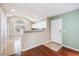 The kitchen has white cabinetry, granite countertops, and an adjacent dining area filled with natural light at 8739 Grassy Oak Trl, North Charleston, SC 29420
