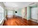 Bright living room featuring hardwood floors, a ceiling fan, and access to the backyard through French doors at 8739 Grassy Oak Trl, North Charleston, SC 29420