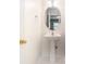 Cozy powder room featuring a pedestal sink, round mirror, and a clean design at 8739 Grassy Oak Trl, North Charleston, SC 29420
