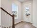 Inviting foyer with beautiful hardwood floors, a staircase, and a door with sidelights, creating a warm entrance at 88 French Garden Cir, Summerville, SC 29486