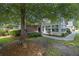 Charming single-story home features a brick facade, mature trees, and manicured landscaping at 103 Ashley Villa Cir # D, Charleston, SC 29414