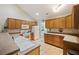 Bright kitchen featuring wood cabinetry, neutral countertops, and modern appliances at 103 Ashley Villa Cir # D, Charleston, SC 29414