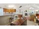 Open living room and kitchen space with a fireplace, breakfast bar, and lots of natural light at 103 Ashley Villa Cir # D, Charleston, SC 29414