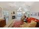 Bright living room with fireplace, vaulted ceilings, and open layout flowing into sunroom and bedroom at 103 Ashley Villa Cir # D, Charleston, SC 29414