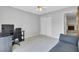 Neutral bedroom featuring light gray walls, ceiling fan, closet, and an adjacent doorway at 103 Greencastle Dr, Goose Creek, SC 29445