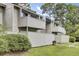 A charming two-story home with a fenced yard, mature trees, and gray wood plank siding at 103 Greencastle Dr, Goose Creek, SC 29445
